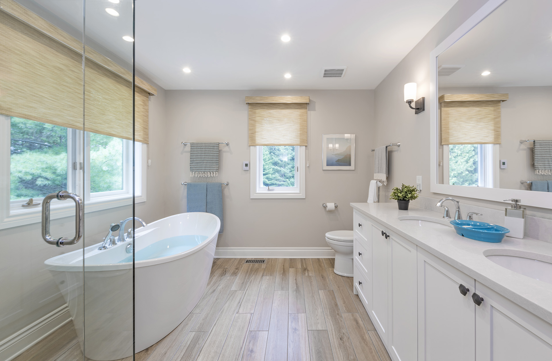 Earth Toned Bathroom with Natural Woven Shades and Large Soaker Tub