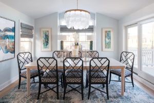 The dining chairs add a touch of tradition to this beachy dining room by Barbara Hayman
