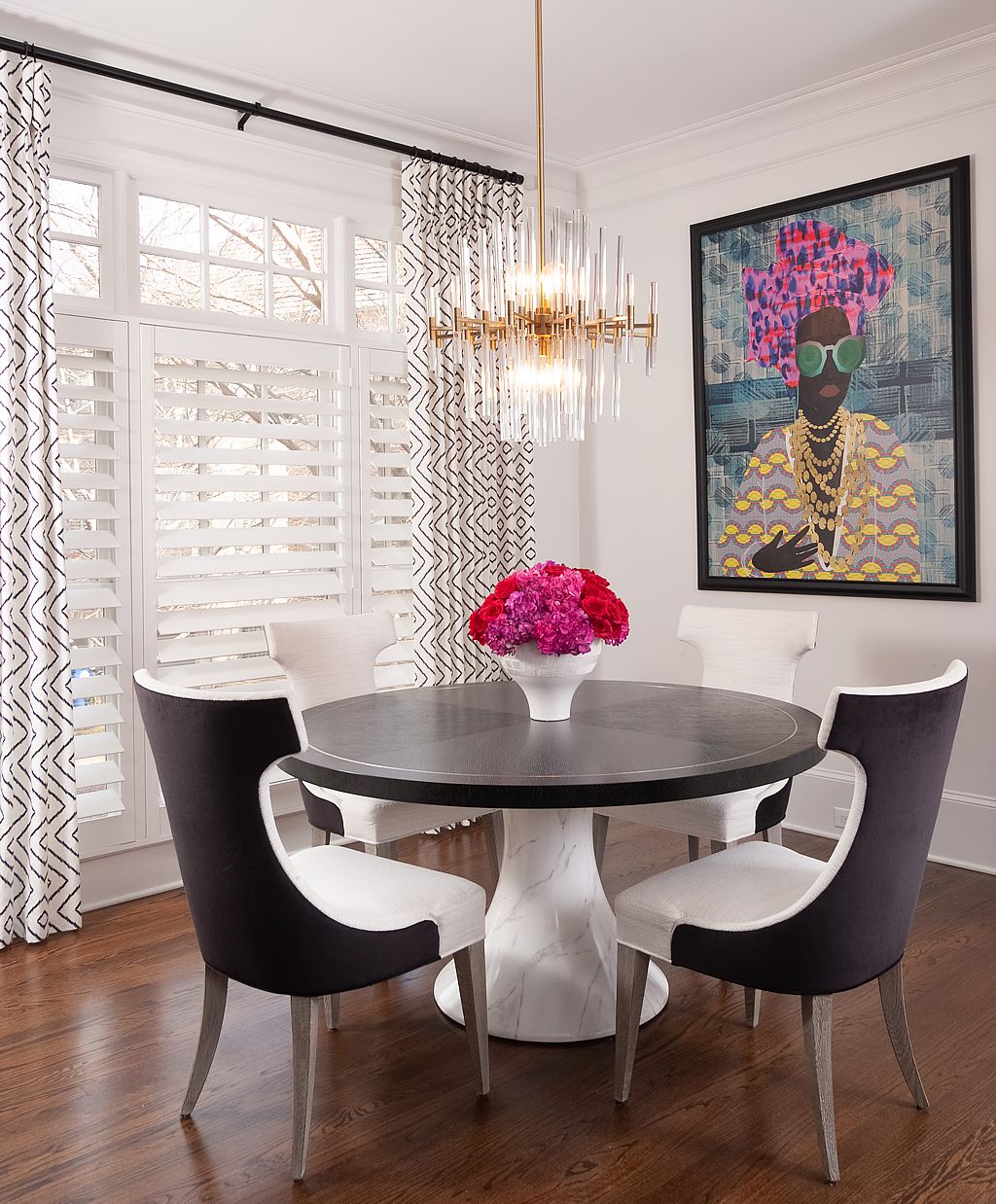 Just a touch of pink in the artwork and flowers of this black and white kitchen.