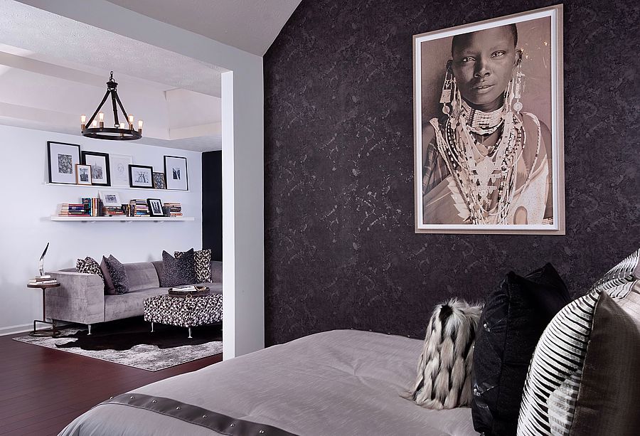 Dark wallpaper makes a sleeping nook feel even more cozy and the wallpaper beautifully contrasts the tribal art.
